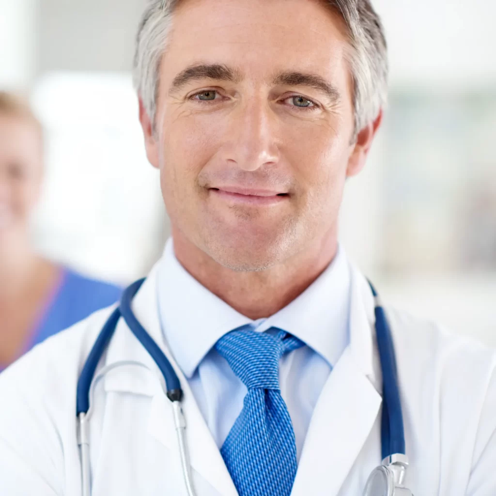 doctor wearing stethoscope smiling in hospital env utc